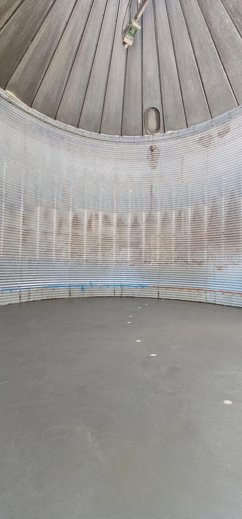 A fresh concrete floor finished inside a corrugated grain bin