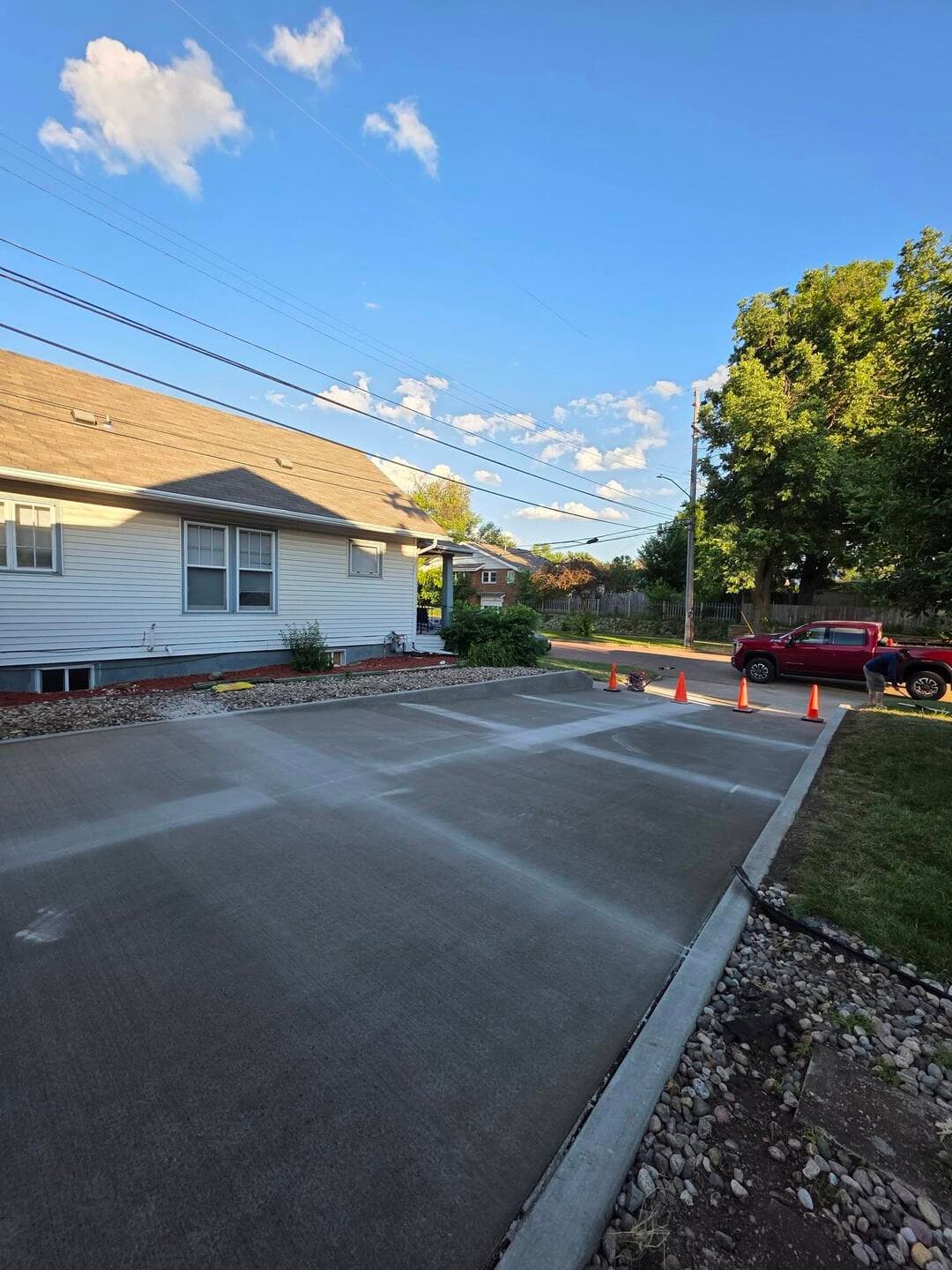 The same driveway poured and broom-finished wide and clean behind the house